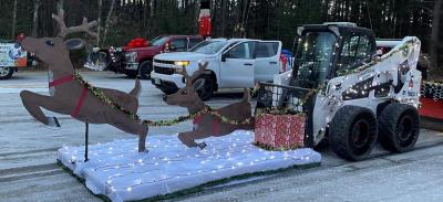 Decorated skid steer and plow truck.